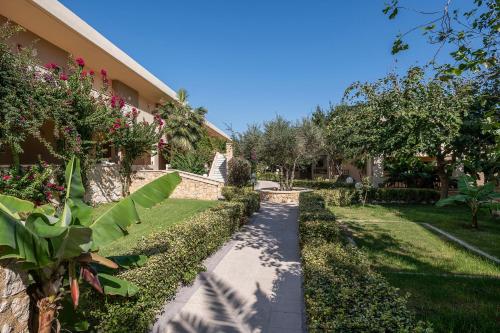 a walkway in a yard next to a building at Indigo Mare in Plataniás