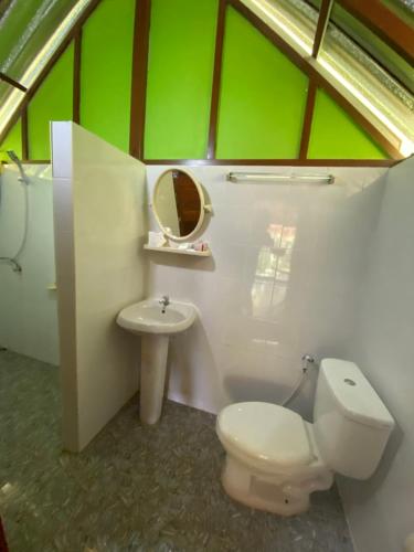 a bathroom with a toilet and a sink at Khaosok Bamboo Huts Resort in Khao Sok National Park