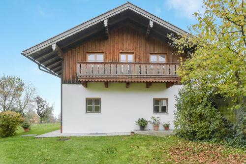 a house with a balcony on top of it at Ferienwohnung Sommerwind in Wackersberg