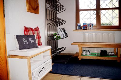 a room with a shelf and a table and a stair case at Landhaus Sonnenberg in Sankt Anton am Arlberg