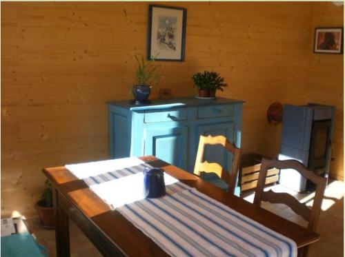 a dining room with a table and a blue cabinet at Pera Rionda in Caprie