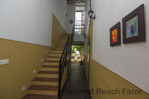 a stairway leading up to a hallway in a building at Coconut Beach Farm in Alibaug