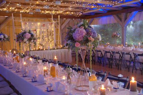a banquet hall with tables with candles and flowers at Külalistemaja Vehendi Motell in Vehendi
