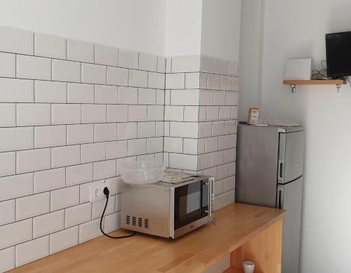 a microwave sitting on a counter in a kitchen at Pension Cando in Porriño