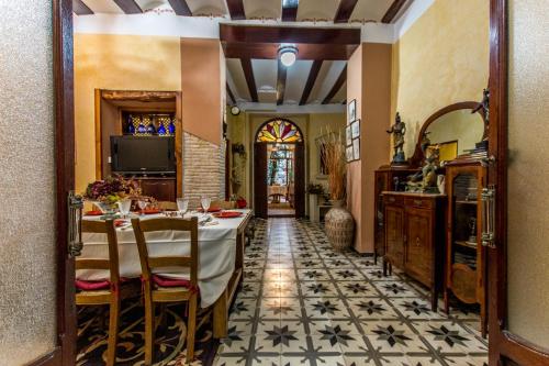 a dining room with a table and a tv at La Casona Albaida in Albaida