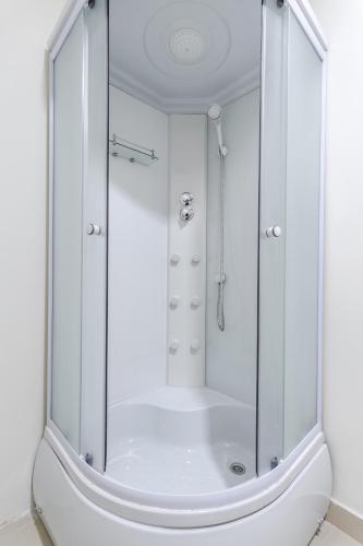 a shower with a glass enclosure in a bathroom at hi Hostel in Lviv