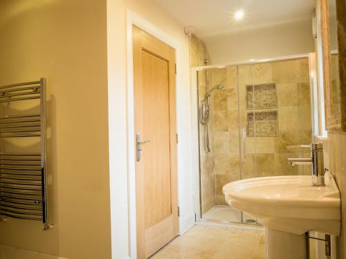 a bathroom with a sink and a shower at The Apartment at Mullans Bay in Kesh