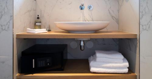 a bathroom with a sink and a bath tub at WesterVilla in Amsterdam
