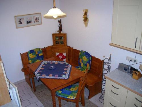 a kitchen with a table and chairs and a dining room at Annettes Ferienstübchen in Bad Berka