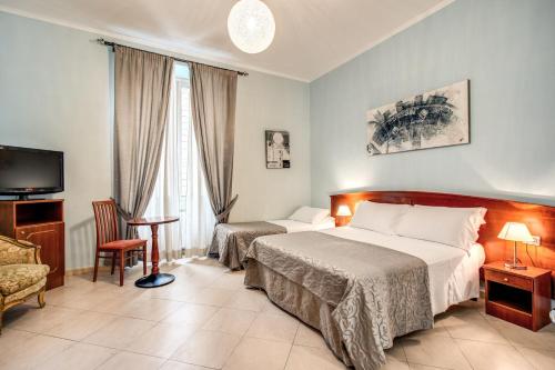 a hotel room with two beds and a television at Residenza Praetoria in Rome