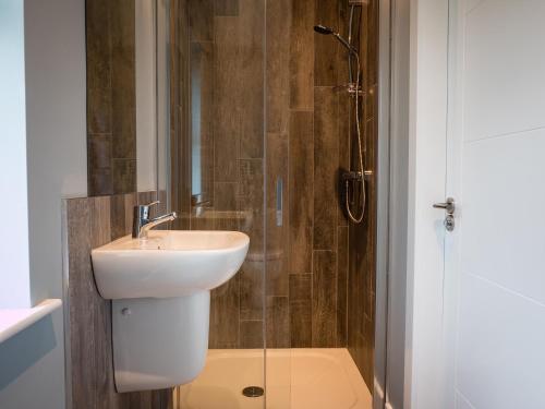 a bathroom with a sink and a shower at Executive Lakeside Lodge at Mullans Bay in Kesh