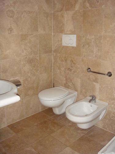 a bathroom with a toilet and a sink at Residence Mediterraneo in Marina di Grosseto