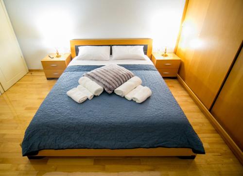 a bedroom with a bed with two pillows at Vier Luxury House in Serres