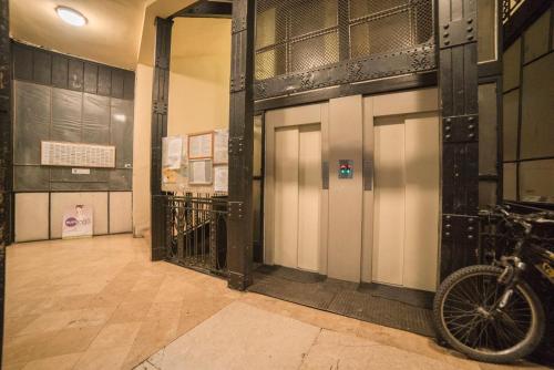 a hallway with two doors and a bike parked on the floor at Maria Boutique Suits in Budapest