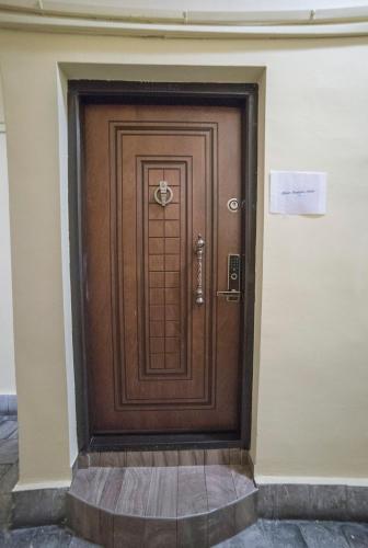 a brown door on a building with a sign on it at Maria Boutique Suits in Budapest