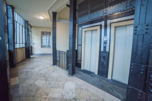 an empty hallway with doors in a building at Maria Boutique Suits in Budapest