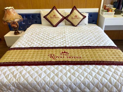 a bed with a royal hotel sign on it at The Royal Hotel Near West Lake in Hanoi