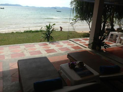 a living room with a view of the beach at Koh Kwang Seaview in Klong Muang Beach