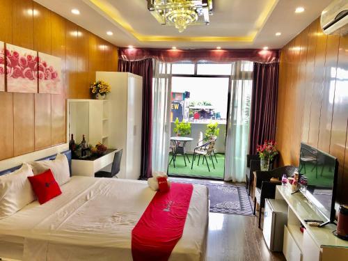 a bedroom with a bed with a red blanket on it at The Royal Hotel Near West Lake in Hanoi