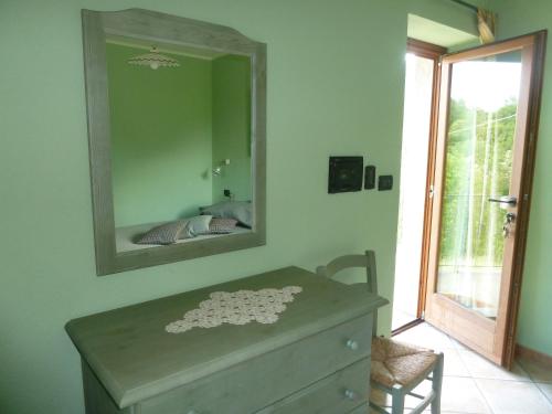 a dresser in a room with a mirror at L'Antica Dimora in Perosa Argentina