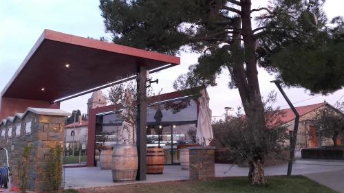 a building with a red awning next to a tree at Holiday House Ida in Marezige