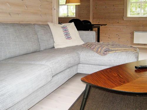 a gray couch in a living room with a table at 6 person holiday home in Skibby in Skibby