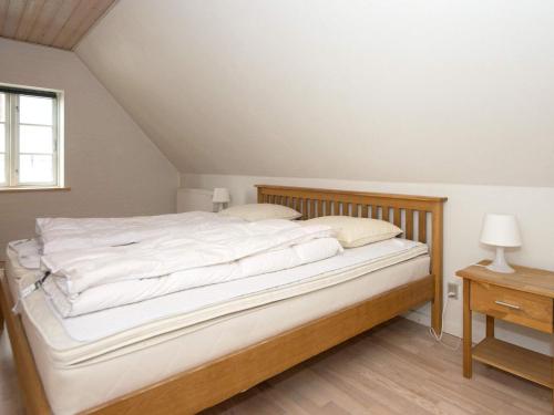 a bedroom with a large bed with white sheets at 20 person holiday home in Nordborg-By Traum in Nordborg