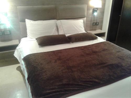 ein großes Bett mit zwei Kissen darüber in der Unterkunft Appartement Bella Vista in Bouznika