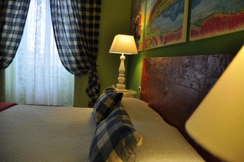 a bedroom with a bed with a lamp on it at Casa Martini in Rome
