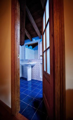 an open door to a bathroom with a sink at La Indiana in Poo de Cabrales