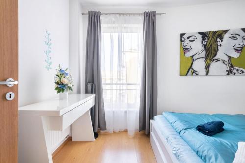 A bed or beds in a room at Matthias Home Midtown Budapest