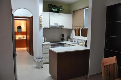 una cocina con armarios blancos y una isla de cocina en 2 Bed, 2 Bath Apartment In Mandria, en Mandriá