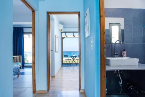 a bathroom with a sink and a view of the ocean at Rhodes Sea Villas in Ixia