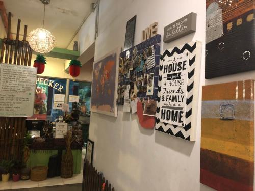 a wall in a store with posters on it at Woodpecker Lodge, Kuching in Kuching