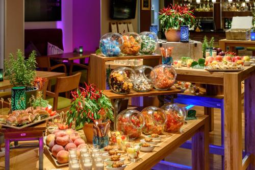 a buffet of food on display in a restaurant at Mercure Hotel Köln West in Cologne