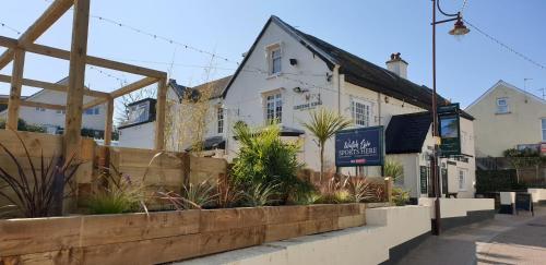 a building on the side of a street with plants at The Eyre Court in Seaton