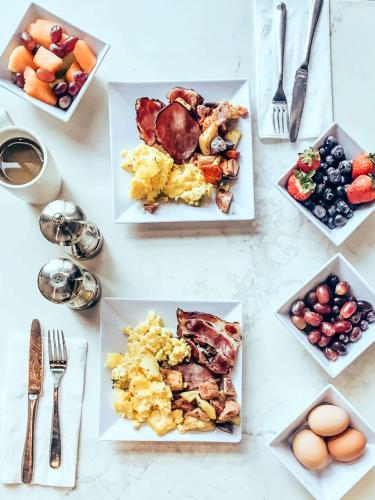 a table with plates of breakfast food on it at Hyatt Place Kansas City/Overland Park/Convention Center in Overland Park