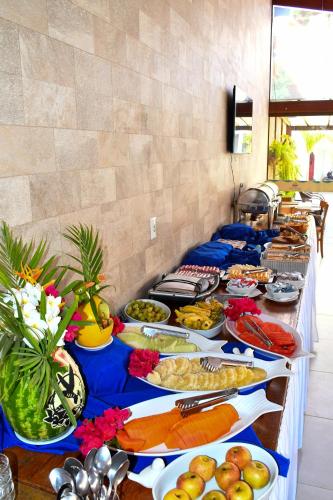 a buffet line with many different plates of food at Pousada Sol e Mar in Maragogi