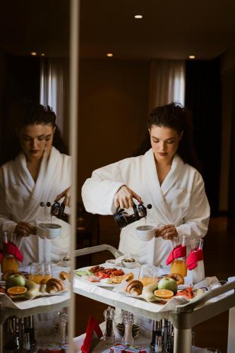 two people in white chefs preparing food on a table at Privilege Hotel & Spa in Tirana