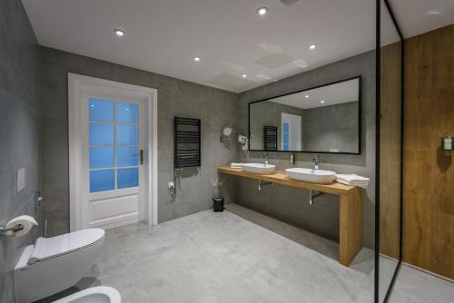a bathroom with two sinks and a mirror at Hotel Prezydent in Spała