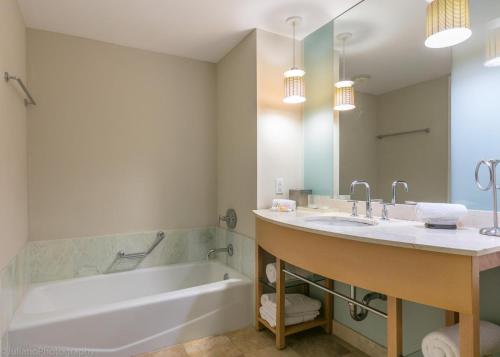 a bathroom with a tub and a sink and a bath tub at Ocean View 25th floor at Marenas Beach Resort by AmmosFL in Miami Beach