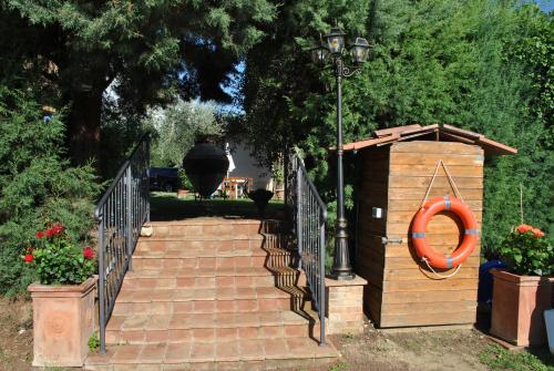 a set of stairs with a gate and a house at Agriturismo la Nicchia in Castelnuovo Berardenga