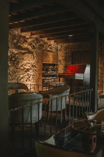 a room with chairs and a table and a piano at Hotel Museo Spa Casa Santo Domingo in Antigua Guatemala