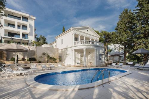 a swimming pool in front of a building at Vila Alta in Selce