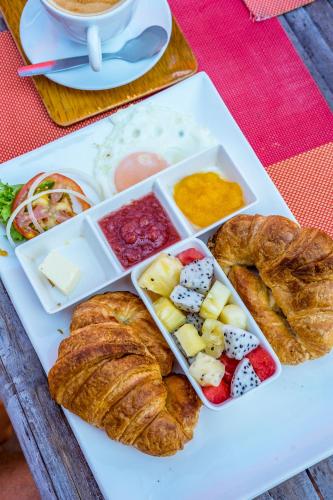 Ein Tablett mit Gebäck und Croissants auf einem Tisch in der Unterkunft Secret Garden Beach Resort in Bangrak Beach