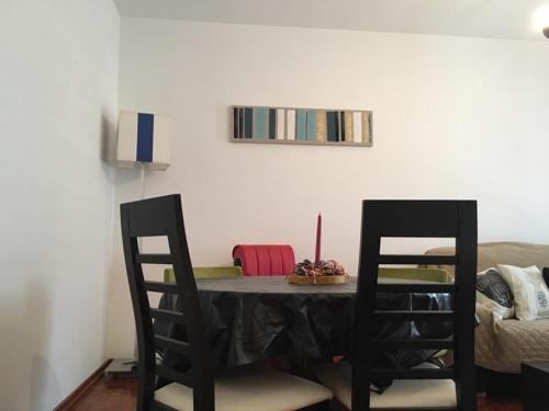 a dining room table with two chairs and a bed at CASA JUDITE in Faro
