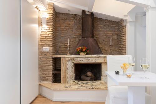 a living room with a stone fireplace and a table at Pantheonview - Luxury Suites in Rome