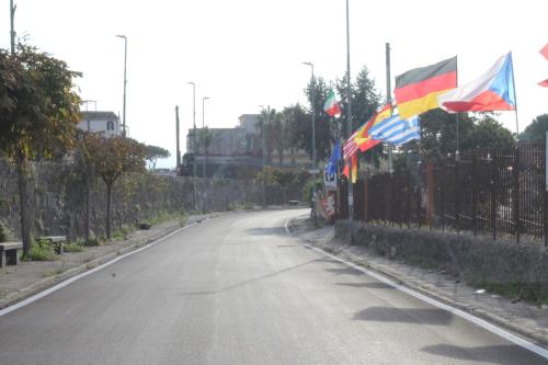 an empty street with flags on a fence at B&B Magma in Ercolano