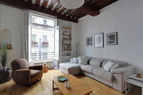 a living room with a couch and a table at Luminous Loft in Saint-Germain des Prés in Paris