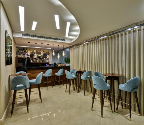 ein Restaurant mit Tischen und Stühlen und eine Bar in der Unterkunft Sodeco Suites in Beirut